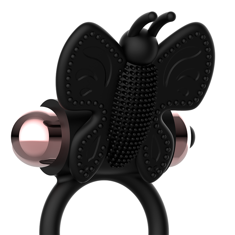 Anillo vibrador negro y dorado con diseño mariposa, parte de la línea Coquette Chic Desire, para mejorar la experiencia íntima.