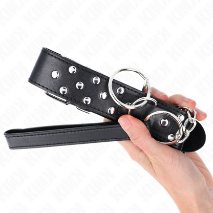 Collar y correa ajustable de KINK en negro con remaches, anilla y longitud de 65 cm, para uso en restricción y juego erótico.