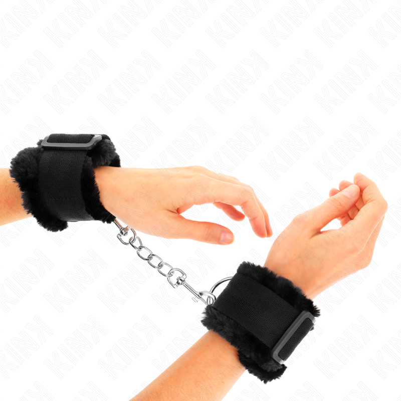 Muñequera forrada ajustable de KINK en color negro, de 17 a 31 cm y 7 cm de ancho, con cierre seguro para restricción.