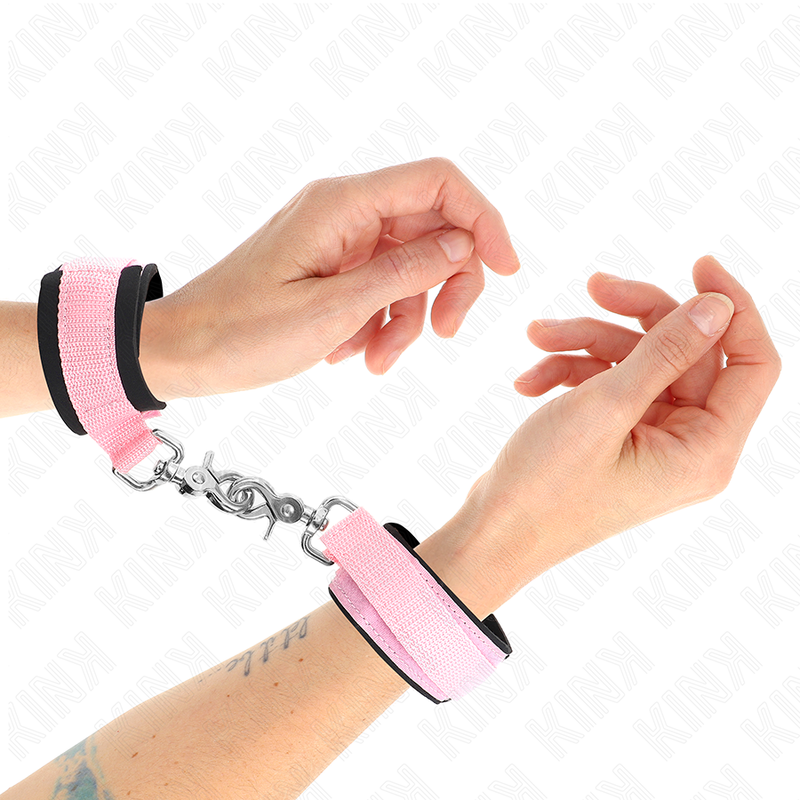 Muñequera ajustable de neopreno rosa de la marca KINK, con longitud de 22 a 34 cm y diseño cómodo y seguro.