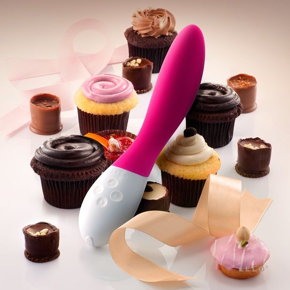 LELO MONA 2 fuchsia vibrator displayed on a soft surface, showcasing its sleek design and ergonomic shape.