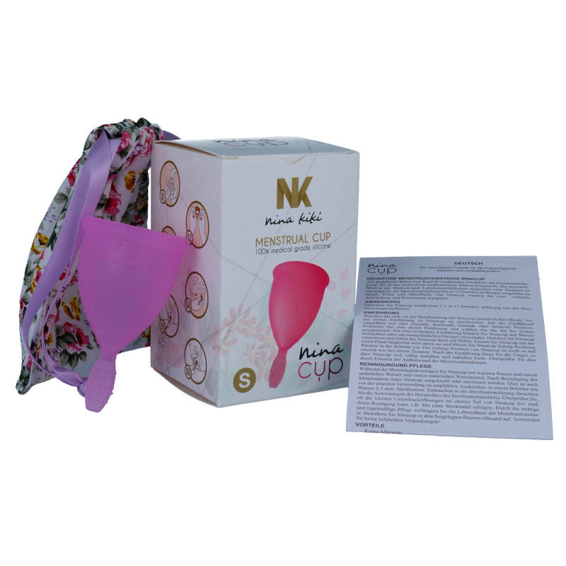 Purple NINA KIKÍ menstrual cup in size S, made of soft silicone, shown in a close-up image highlighting its smooth, flexible design.