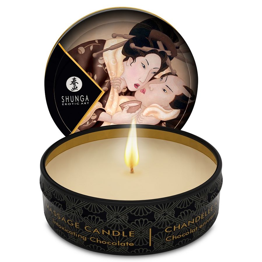 SHUNGA Mini Caress by Candlelight chocolate massage candle in 30 ml container on a soft surface.