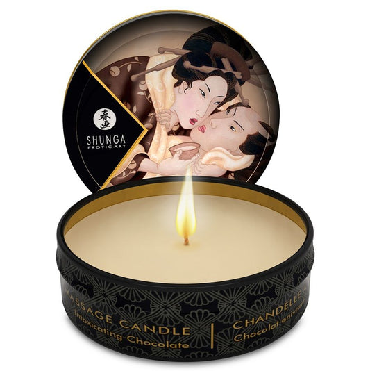 SHUNGA Mini Caress by Candlelight chocolate massage candle in 30 ml container on a soft surface.