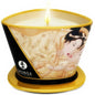 SHUNGA Mini Caress by Candlelight vanilla massage candle in a glass container, melted wax and wick visible.